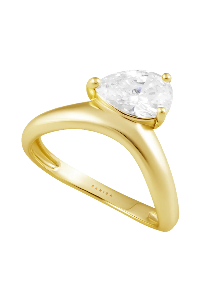 A yellow gold solitaire engagement ring featuring a pear-cut clear gemstone, shown on a plain white background. The brand name 'SALVIA' is engraved on the inner band.